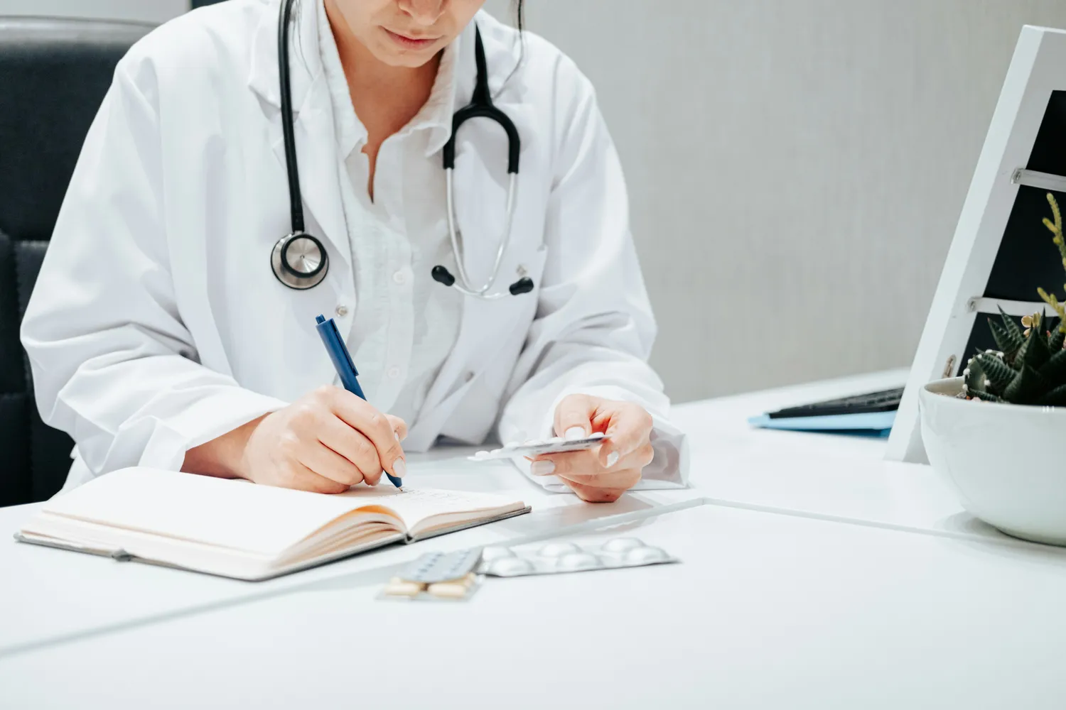 A physician making notes at a desk